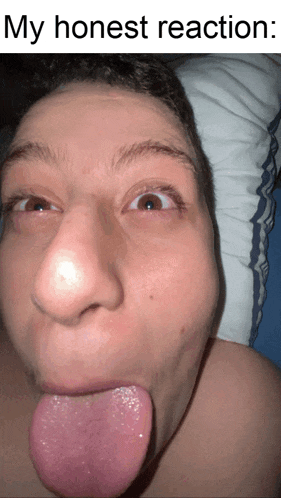 a close up of a person 's face with their tongue sticking out