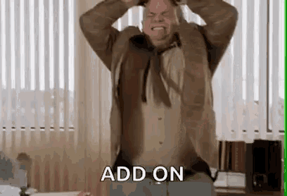 a man in a suit and tie is holding his head while standing in an office .