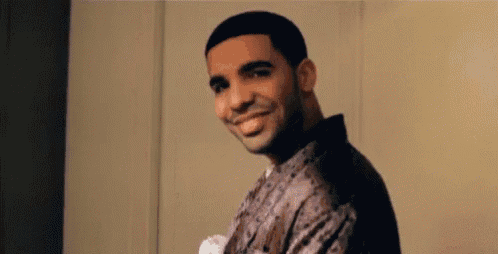 a man is smiling and looking at the camera while wearing a shirt .