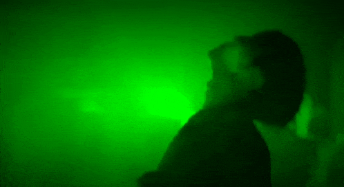 a silhouette of a man in a green light .