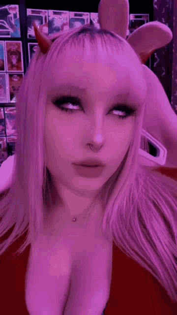 a girl with a nose ring is wearing a headband with horns