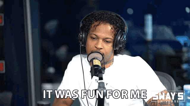 a man wearing headphones talking into a microphone with the words it was fun for me behind him