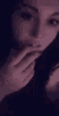 a close up of a woman 's face with a purple background .