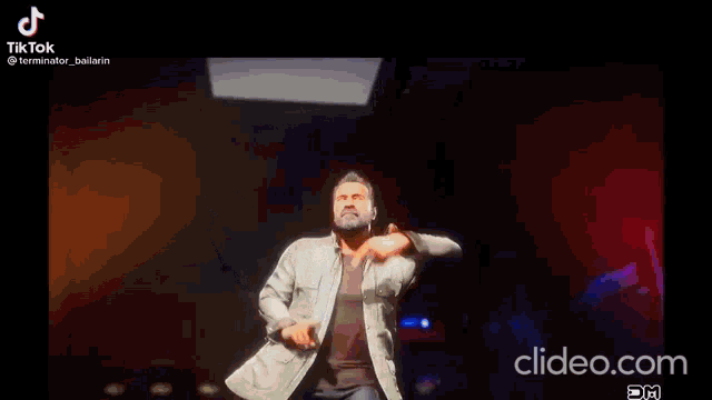 a man is dancing on a stage in a video game while wearing a jacket and jeans .