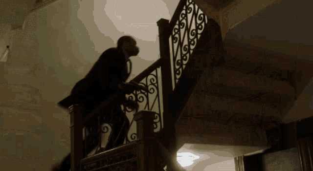 a man in a suit is walking down a set of stairs