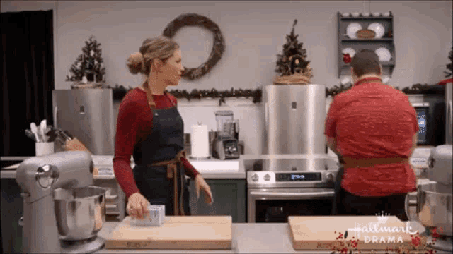 a man and a woman in a kitchen with the words hallmark drama on the bottom right