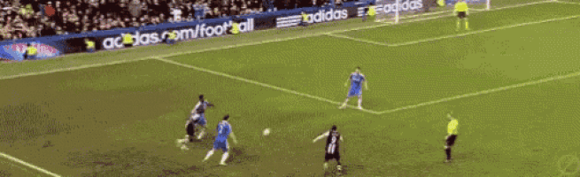 a soccer game is being played on a field that has adidas advertisements