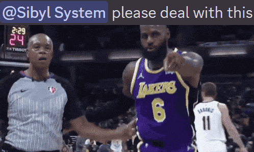 a basketball player wearing a lakers jersey talks to a referee during a game