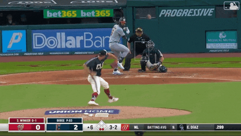 a baseball game is being played in front of a dollarbar ad