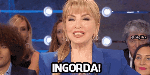 a woman in a blue suit says ingorda in front of a group of people