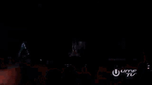 a crowd of people at a concert with a uhf tv logo in the corner