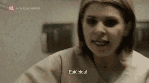 a woman in a scrub top is talking to someone in a hospital room .