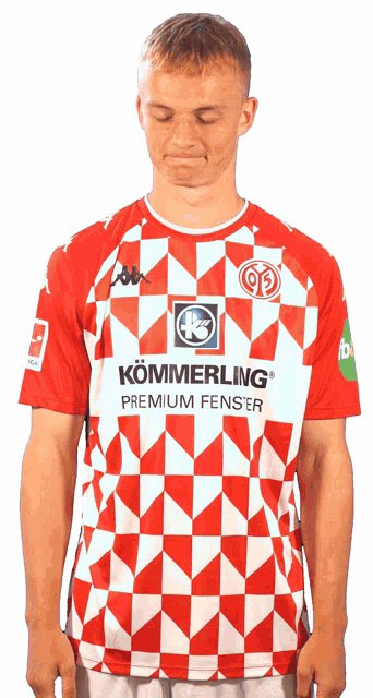 a man wearing a red and white shirt that says kommering premium fenster