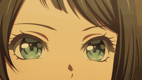 a close up of a girl 's eyes with a slight smirk