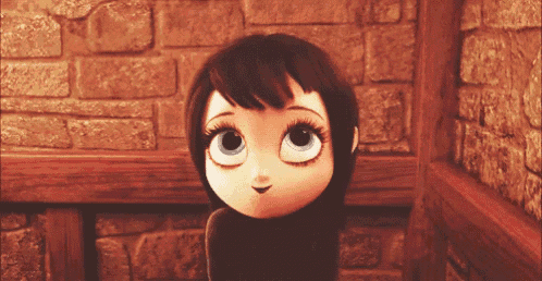 a cartoon character with big eyes is standing in front of a stone wall