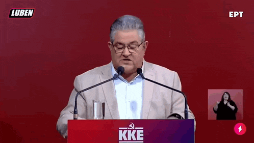 a man is giving a speech at a podium that says kke