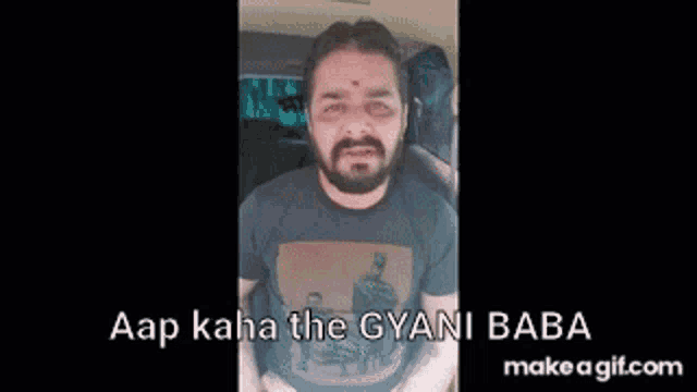a man with a beard is sitting in a car and making a funny face with his hands .