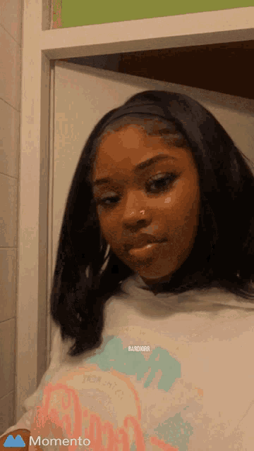 a girl with a nose ring is wearing a hoodie that says bad girl