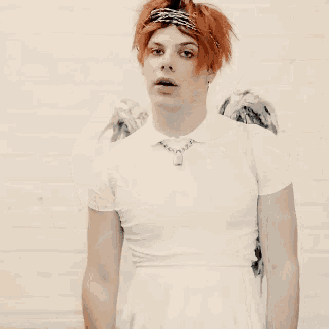 a man with red hair is wearing a white shirt and a white skirt