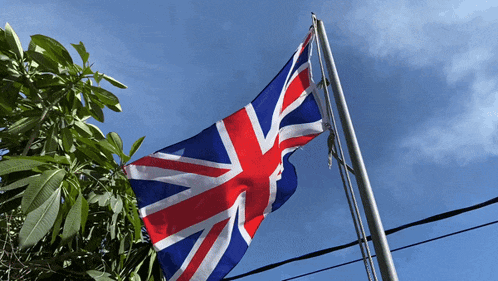 a british flag is flying in the wind