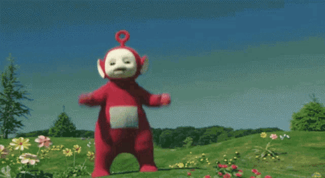 a teletubbies character is standing in a field with his arms outstretched