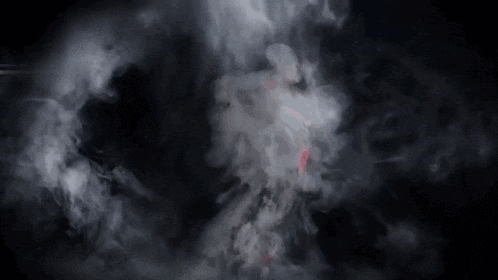 a person is flying through the air in the dark with a red light coming out of their mouth .
