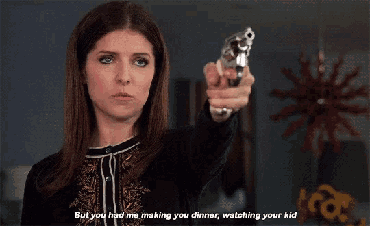 a woman is pointing a gun at the camera with the words but you had me making you dinner watching your kid below her