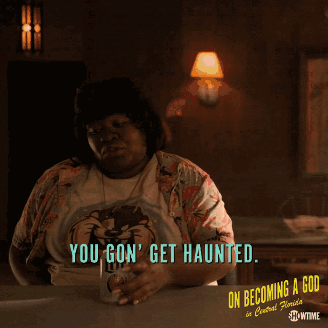 a woman sitting at a table with the words you gon ' get haunted