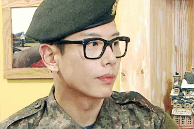 a man in a military uniform wearing glasses and a hat
