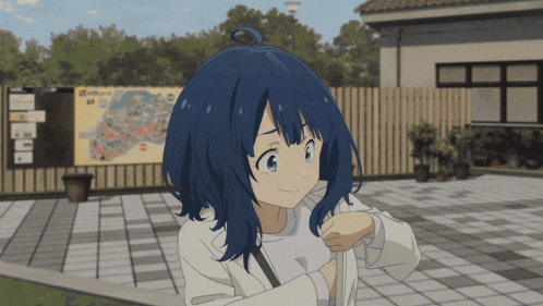 a girl with blue hair is standing in front of a fence