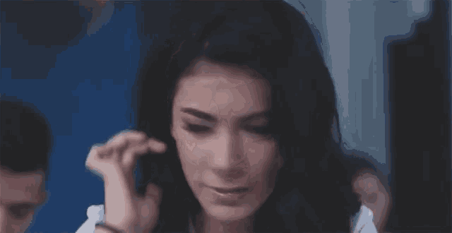 a woman is talking on a cell phone in a room .