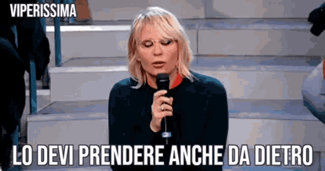 a woman holding a microphone with the words viperissima written above her