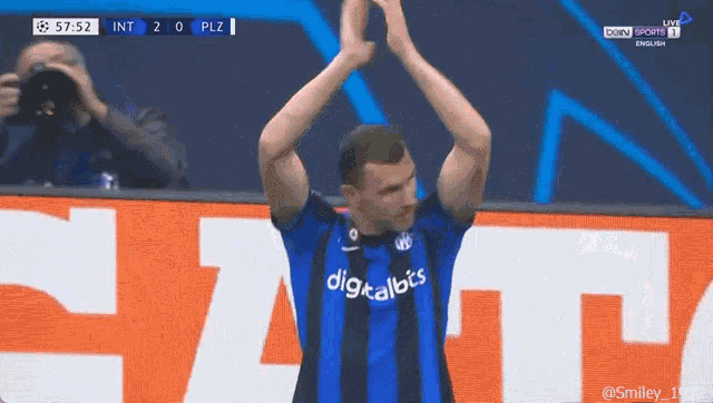 a soccer player wearing a digitalbis jersey applauds his teammates