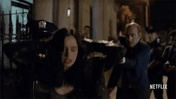 a man in a suit is pointing a gun at a woman in a leather jacket while a netflix ad is displayed