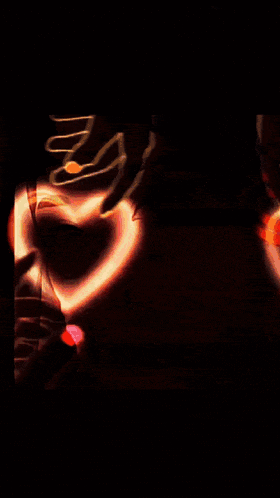 a woman making a heart with her hands and the words love you behind her