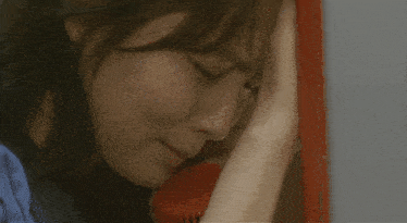 a woman is crying while holding her head in her hand