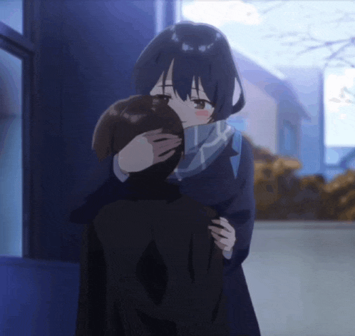 a girl with blue hair is hugging a man