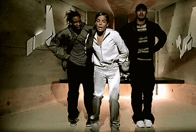 a group of people are standing in a hallway and one of them is wearing a jacket that says ' nike ' on it