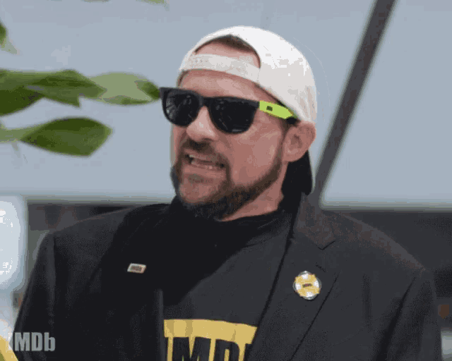 a man with a beard wearing sunglasses and a hat with the word mdb on it