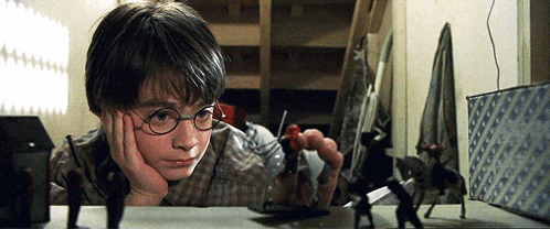 a young boy wearing glasses is playing with a toy soldier