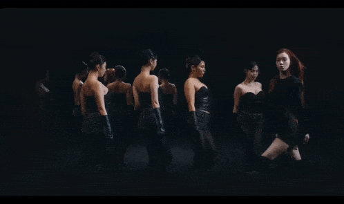a group of women standing in a dark room