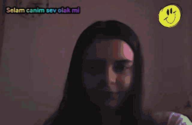 a woman with a smiley face above her head and the words selam canim sev olarak mi