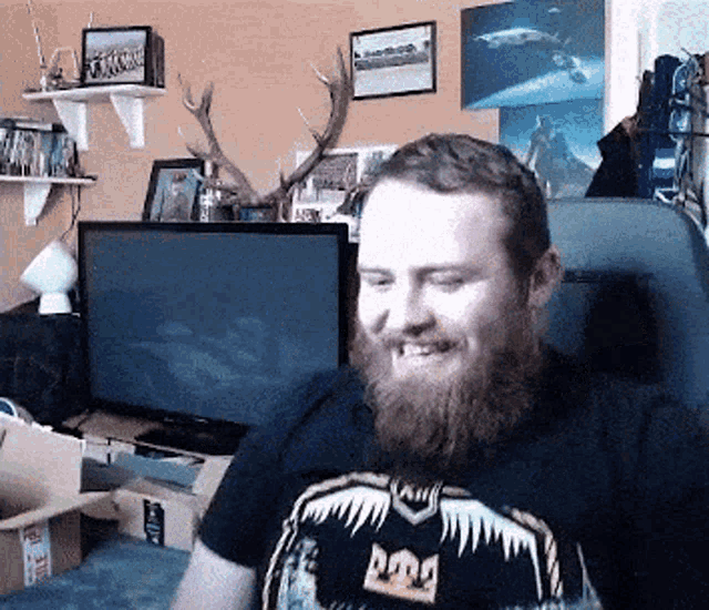 a man with a beard is wearing a shirt that says ' dm ' on it