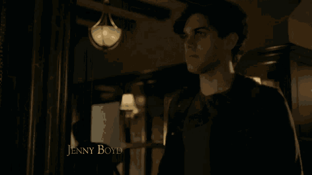 a man in a dark room with the name jenny boyd