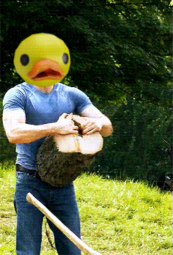 a man with a yellow duck head is cutting a tree