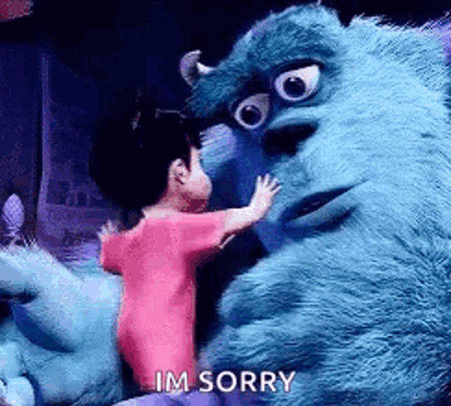 a little girl is hugging a monster from monsters inc . and says `` im sorry '' .