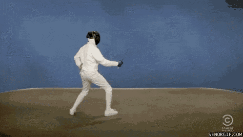 two men in white fencing suits are standing next to each other holding swords .