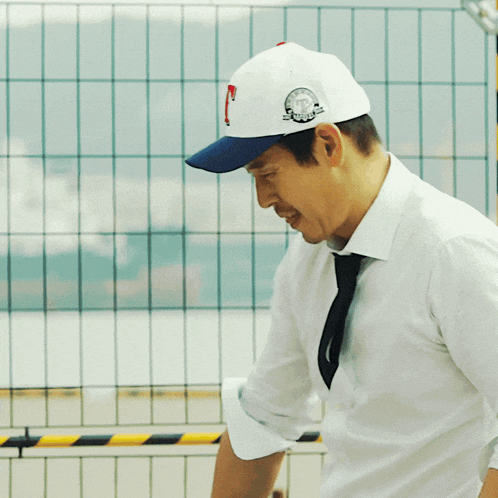 a man wearing a white hat with a clock on the back