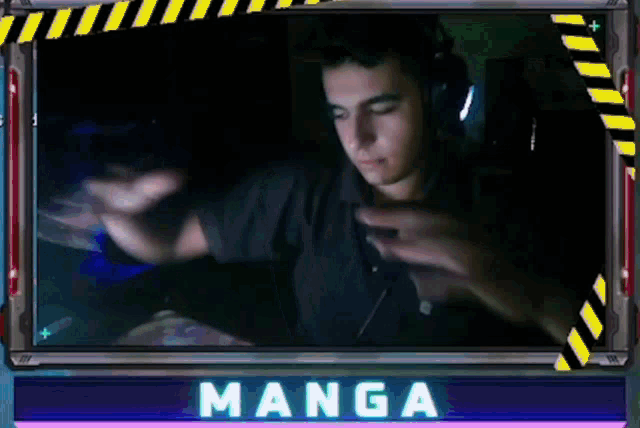 a man wearing headphones is sitting in front of a computer screen with the word manga on it .