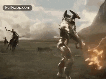 a group of people are riding horses in a field while a robot is standing in the middle of a field .